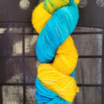 A skein of lemon yellow/sky blue dyed sock yarn