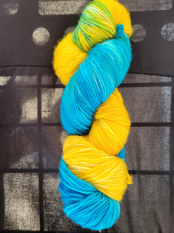 A skein of lemon yellow/sky blue dyed sock yarn