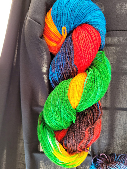A skein of green/yellow/red/blue dyed sock yarn