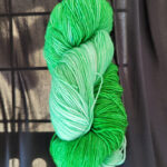 A skein of green gradient dyed sock yarn